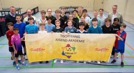 Die Nachwuchsspieler*innen präsentieren das Banner.