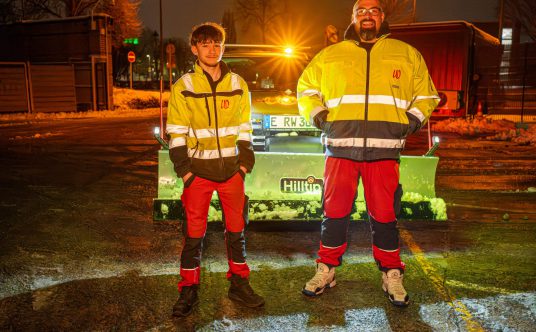 Winterdienst: Zwei Mitarbeiter von Rudolf Weber vor einem Räumfahrzeug.